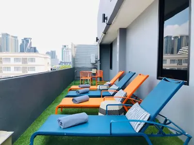 a row of chairs and tables on a balcony at Alt Hotel Nana by UHG in Bangkok