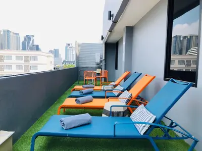 a row of chairs and tables on a balcony at Alt Hotel Nana by UHG in Bangkok