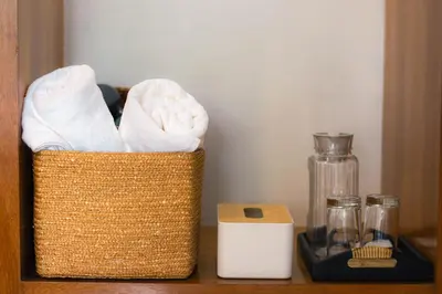 a basket of towels sitting on a shelf with a blender at Alley & Pier in Bangkok