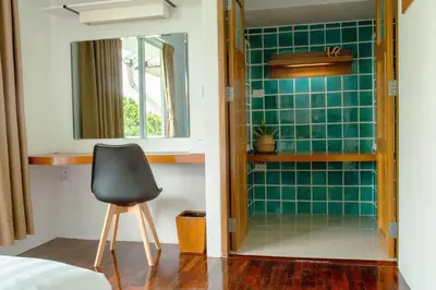 a room with a chair and a mirror in a room at Alley & Pier in Bangkok