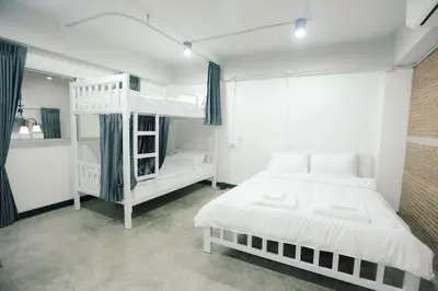 a bedroom with two beds and a bunk bed at G5 Hostel in Bangkok
