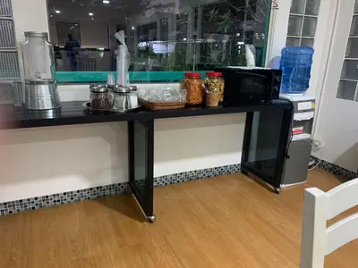 a black table with a microwave on top of it at Baan Sood Soi Residence 1 บ้านสุดซอย เรซิเด้นท์ 1 in Ban Bang Bamru