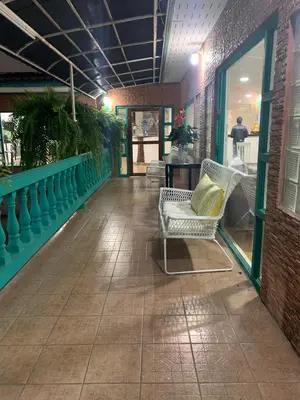 a patio with a chair and a table in a building at Baan Sood Soi Residence 1 บ้านสุดซอย เรซิเด้นท์ 1 in Ban Bang Bamru