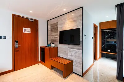 a room with a wall with a flat screen tv at Frame Hotel Bangkok in Bangkok