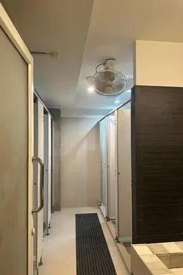 a hallway with a ceiling fan and a hallway with a hallway at Qilombo Hostel Silom in Bangkok