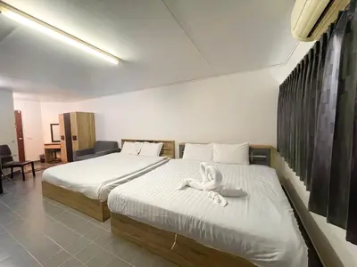 a bedroom with two beds with a stuffed animal on the bed at ห้องพักรายวันเมืองทองธานีตึกc5 (คุณแอ๊ด) in Thung Si Kan