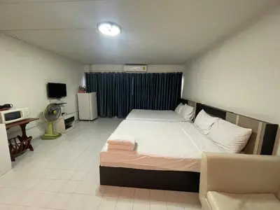 a bedroom with a large bed and a television at ห้องพักรายวันเมืองทองธานีตึกc5 (คุณแอ๊ด) in Thung Si Kan