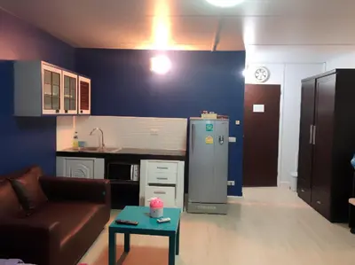 a living room with a couch and a refrigerator at ห้องพักรายวันเมืองทองธานีตึกc5 (คุณแอ๊ด) in Thung Si Kan