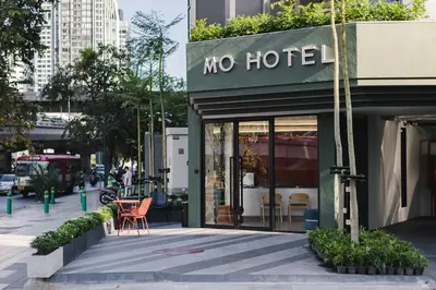 a store with a no hotel sign on a city street at MO Hotel Bangkok in Bangkok