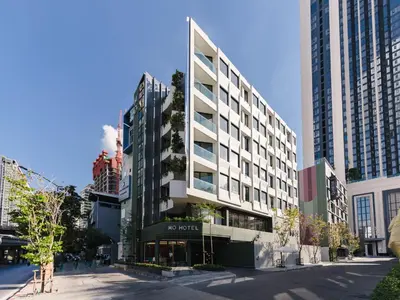 a building on a city street with tall buildings at MO Hotel Bangkok in Bangkok