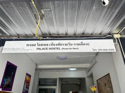 a sign hanging from the ceiling of a building at OYO 75577 Palace Hostel in Amphoe Phra Khanong