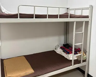 a couple of bunk beds in a room at OYO 75577 Palace Hostel in Amphoe Phra Khanong