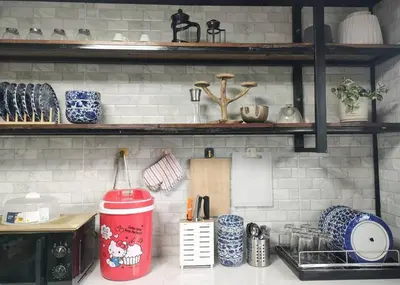 a kitchen with a counter top with blue and white dishes at Thananya Apartment in Amphoe Phra Khanong