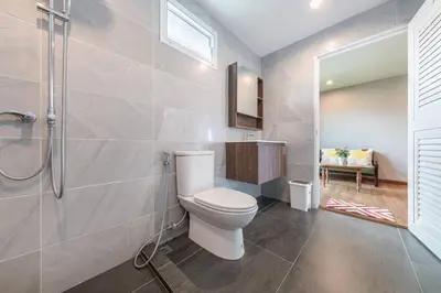 a bathroom with a toilet and a shower at Thananya Apartment in Amphoe Phra Khanong