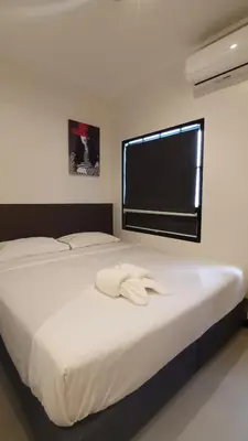 a bedroom with a white bed with a window at The Blocks Hostel Sukhumvit 10 in Bangkok
