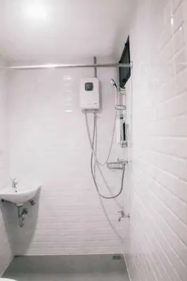 a bathroom with a shower and a sink at Jira19Hostel in Bangkok