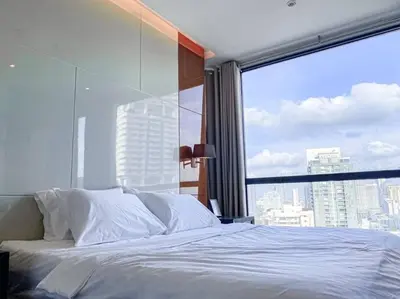 a bedroom with a white bed with a large window at Grand Modern 2BR - Ultra Fast WiFi - Phrom Phong in Bangkok