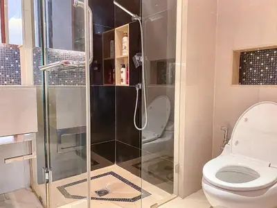 a bathroom with a shower and a toilet at Grand Modern 2BR - Ultra Fast WiFi - Phrom Phong in Bangkok