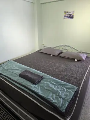 a bed with two pillows on it in a room at 812 Quiet AC Apartment with Balcony & free Wifi in Bangkok