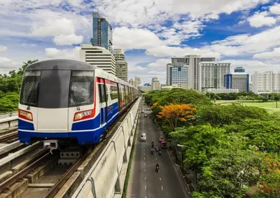a train on a bridge in a city at 812 Quiet AC Apartment with Balcony & free Wifi in Bangkok