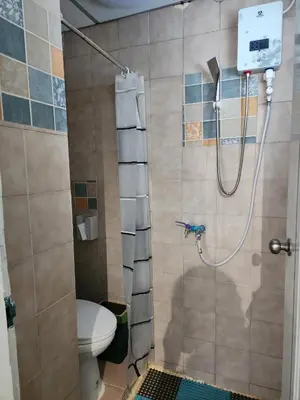a bathroom with a shower with a toilet in it at 812 Quiet AC Apartment with Balcony & free Wifi in Bangkok