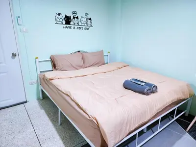 a bed with a suitcase sitting on top of it at 814-STP Homely room Free Wi-Fi and Near BTS line in Bangkok