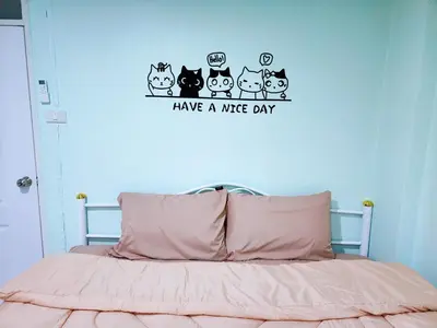 a bedroom with a bed with have a nice day stickers at 814-STP Homely room Free Wi-Fi and Near BTS line in Bangkok