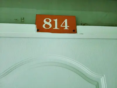 a orange sign on top of a white shelf at 814-STP Homely room Free Wi-Fi and Near BTS line in Bangkok