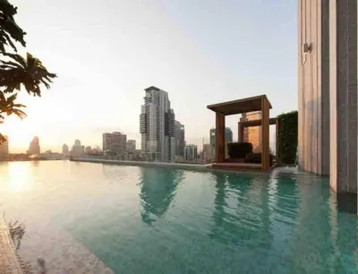 a swimming pool on top of a building with a city skyline at Expansive Modern - BTS Phrom Phong - Ultra Fast WiFi in Khlong Toei