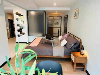 a bedroom with a bed with a laptop on it at Serene home in the heart of BKK - The Great Wave in Bangkok