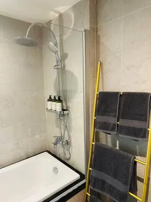 a bathroom with a shower and a sink and towels at Serene home in the heart of BKK - The Great Wave in Bangkok