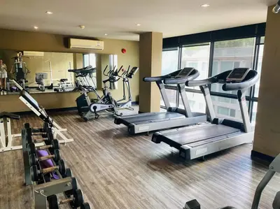 a gym with several treadmills and cardio machines at Serene home in the heart of BKK - The Great Wave in Bangkok