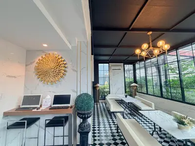 a lobby with two laptops on a table and chairs at Marigold Sukhumvit - Free Shuttle to BTS Bearing Station in Bangkok