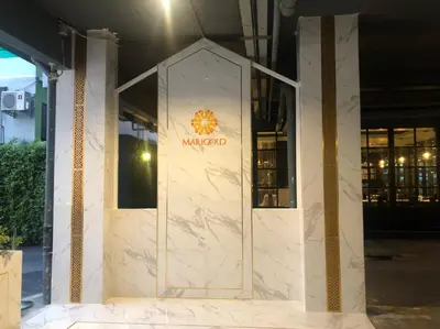 a marble lobby with a sign on the front of a building at Marigold Sukhumvit - Free Shuttle to BTS Bearing Station in Bangkok