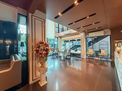 a lobby with a vase of flowers on a table at Marigold Sukhumvit - Free Shuttle to BTS Bearing Station in Bangkok