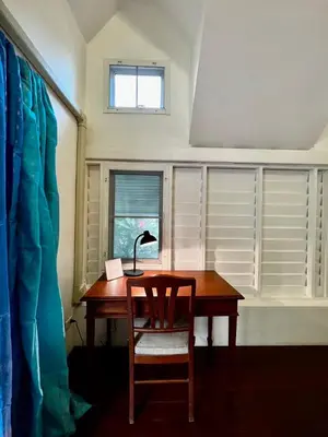 a desk with a lamp and a chair in a room at The Backyard 28 in Khlong Toei
