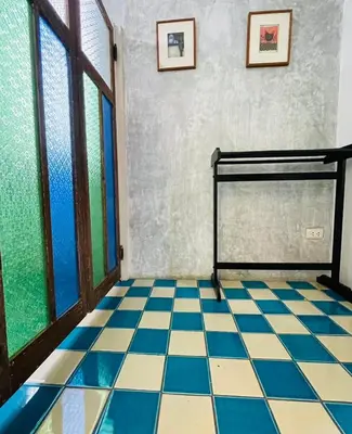a room with a bed and a tiled floor at The Backyard 28 in Khlong Toei