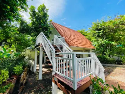 a white staircase leading up to a house at The Backyard 28 in Khlong Toei
