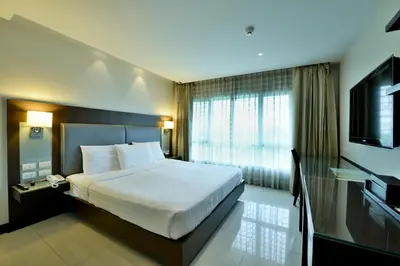 a hotel room with a bed and a television at The Prestige Nana in Bangkok