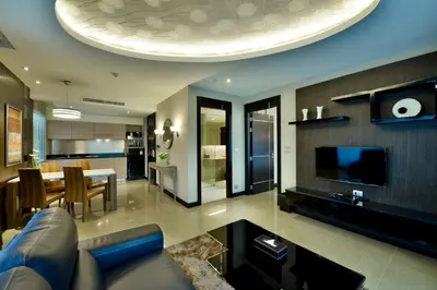 a living room with a couch and a dining room at The Prestige Nana in Bangkok