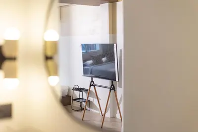 a television on a tripod in a room at Theme Stories - Boutique Guesthouse in Bangkok