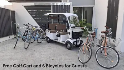 a golf cart and six bicycles for guests at Green Lung Pool Villas Bangkok in Bang Krasop
