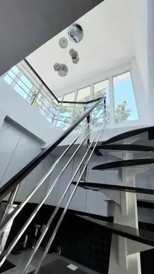 a glass staircase in a building with a skylight at Green Lung Pool Villas Bangkok in Bang Krasop