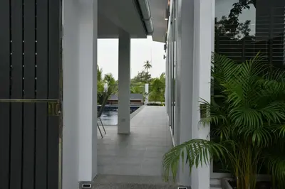 an open hallway of a house with plants at Green Lung Pool Villas Bangkok in Bang Krasop