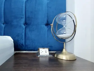 a mirror sitting on a table next to a clock at Green Lung Pool Villas Bangkok in Bang Krasop