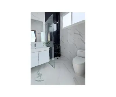 a bathroom with a toilet and a sink and a mirror at Green Lung Pool Villas Bangkok in Bang Krasop