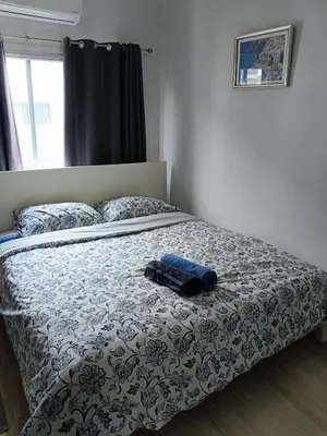 a bed in a bedroom with a blue object on it at Green home in the big City in Bangkok