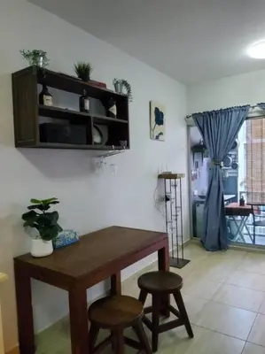 a dining room with a table and two stools at Green home in the big City in Bangkok
