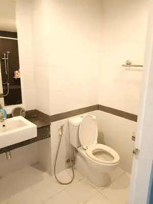 a bathroom with a toilet and a sink at Green home in the big City in Bangkok