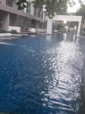 a large pool of water in front of a building at Green home in the big City in Bangkok